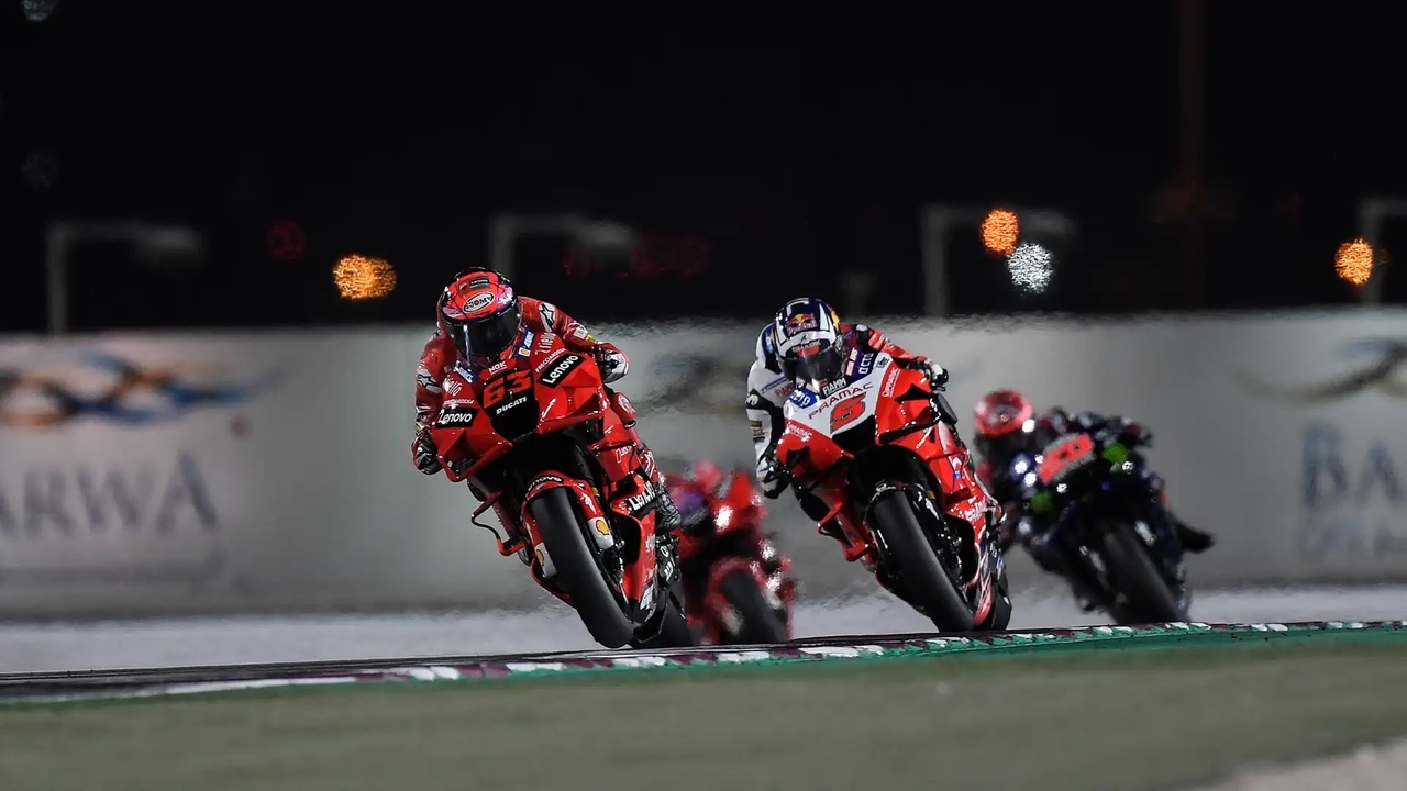 MotoGP bikes racing at night at Lusail Circuit, Qatar 