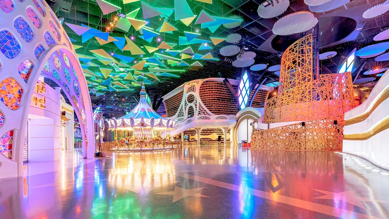 Colourful indoor play zone and carousel ride inside Doha Quest theme park.