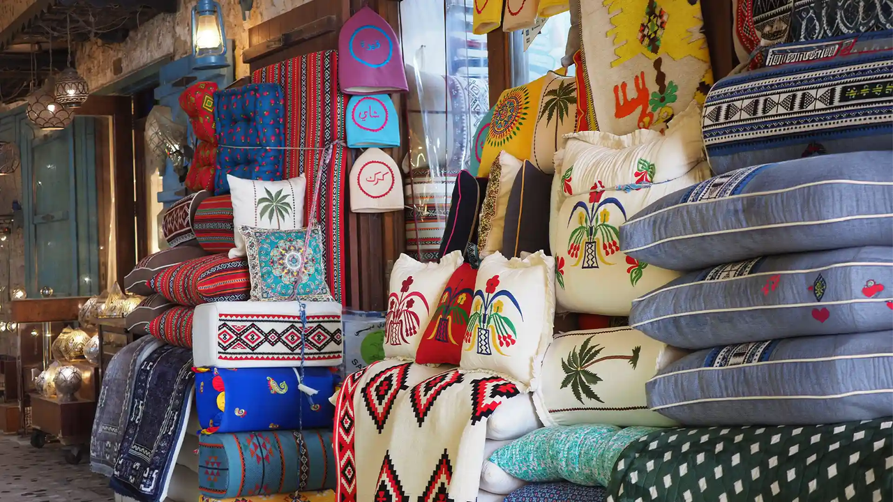 Colourful cushions and textiles on display at Souq Waqif market in Doha