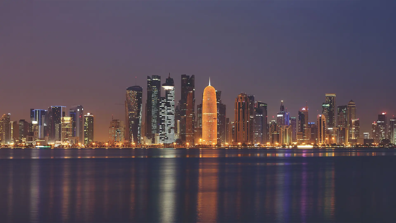 Doha city skyline at night reflected on the water 