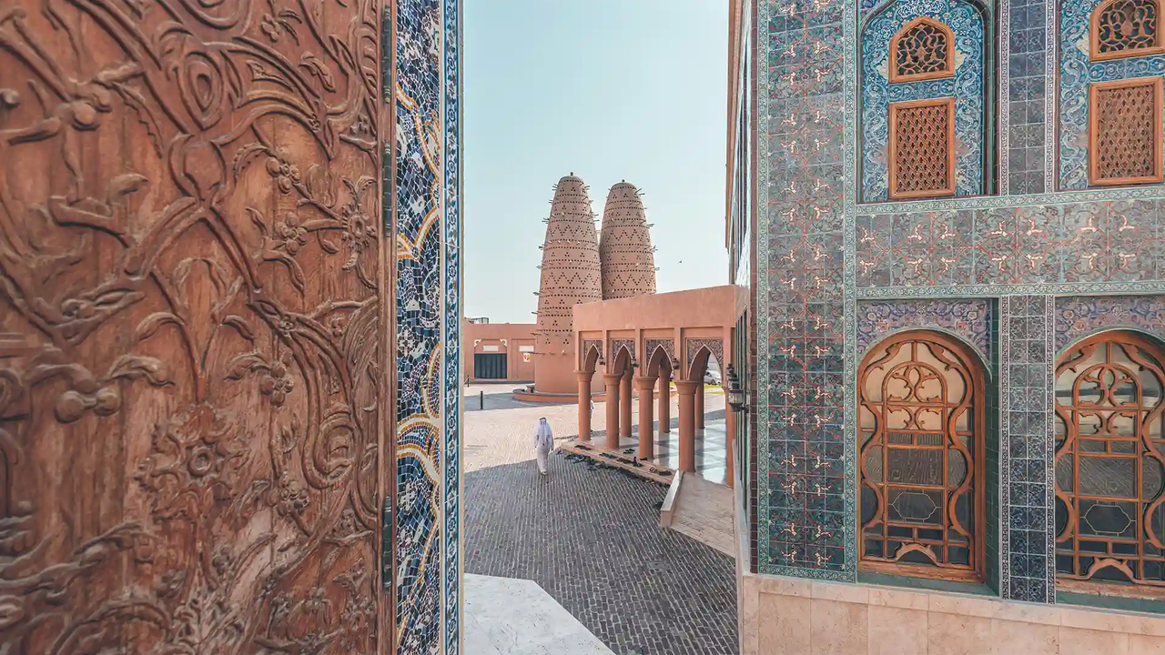 Intricately tiled buildings and traditional pigeon towers at Katara Cultural Village in Doha.