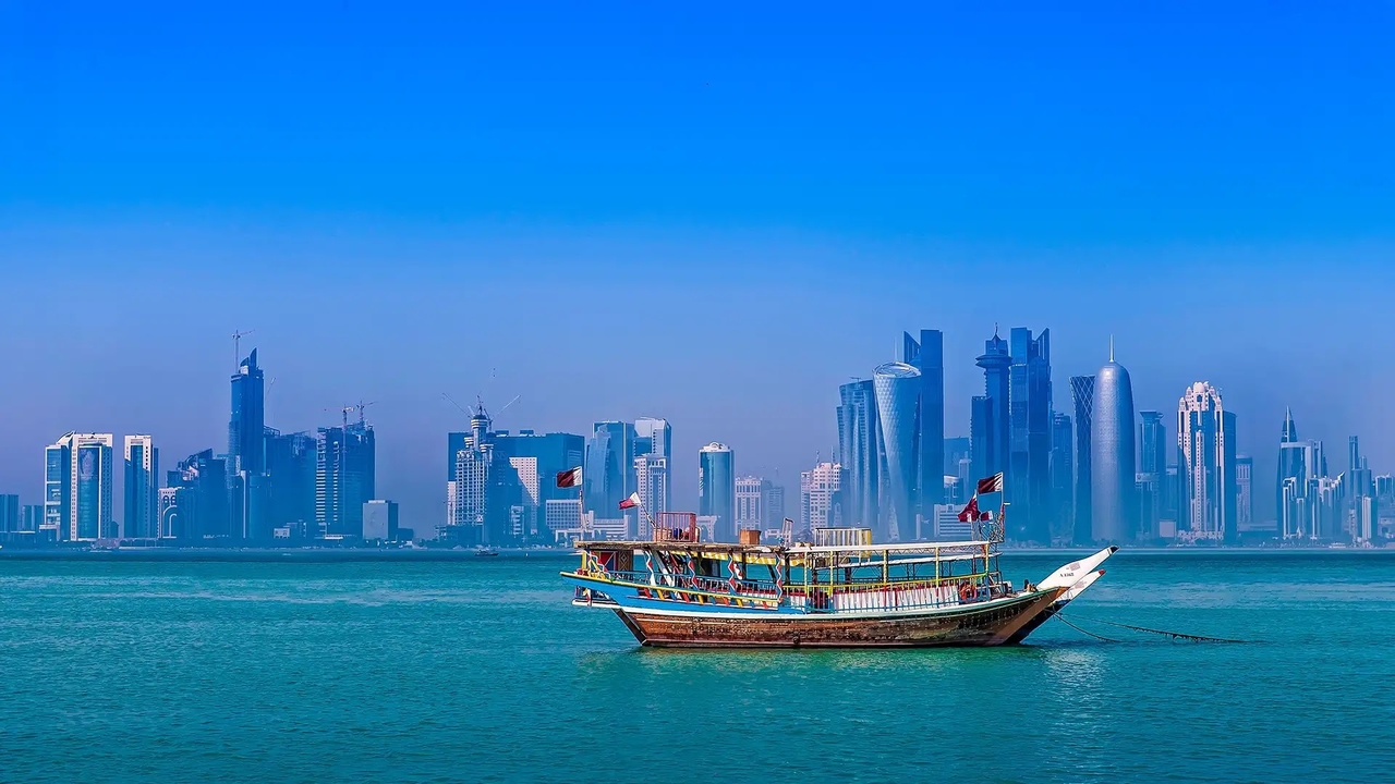 Traditional dhow boat on the water with the West Bay Doha skyline